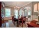 Elegant dining room with hardwood floors, chandelier, and ample natural light at 2223 Shaftesbury Rd, Carmel, IN 46032