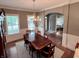 Elegant dining room with hardwood floors, decorative chandelier, and windows for natural light at 2223 Shaftesbury Rd, Carmel, IN 46032