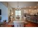 Elegant dining room with a large wooden table, comfortable seating, and views into the kitchen at 2223 Shaftesbury Rd, Carmel, IN 46032