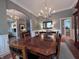 Elegant dining room with a large table, chandelier, and seamless transition to other living spaces at 2223 Shaftesbury Rd, Carmel, IN 46032