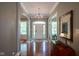 Welcoming foyer features gleaming hardwood floors, elegant chandelier, and neutral paint at 2223 Shaftesbury Rd, Carmel, IN 46032