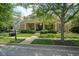 Attractive exterior showcasing landscaped yard, brick facade, and covered front porch at 2223 Shaftesbury Rd, Carmel, IN 46032