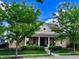 Charming home with manicured landscaping and a welcoming front porch with white pillars at 2223 Shaftesbury Rd, Carmel, IN 46032