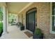 Inviting covered front porch with columns, seating, and stylish brickwork at 2223 Shaftesbury Rd, Carmel, IN 46032