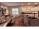 Bright kitchen featuring stainless steel appliances, granite counters, and an eat-in breakfast bar at 2223 Shaftesbury Rd, Carmel, IN 46032