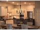 Well-lit kitchen with stainless steel appliances, white cabinets, granite countertops, and dining area at 2223 Shaftesbury Rd, Carmel, IN 46032