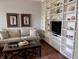 Bright and inviting living room features built-in shelving, hardwood floors and soft, neutral colors at 2223 Shaftesbury Rd, Carmel, IN 46032
