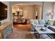 Open living room showcasing hardwood floors, an archway, kitchen view, and comfortable seating at 2223 Shaftesbury Rd, Carmel, IN 46032