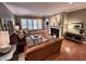 Inviting living room with a fireplace, hardwood floors and lots of windows for natural light at 2223 Shaftesbury Rd, Carmel, IN 46032