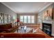 Comfortable living room with hardwood floors, fireplace, and plenty of natural light at 2223 Shaftesbury Rd, Carmel, IN 46032