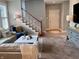 Cozy living room with a staircase, comfortable seating, and natural light from large windows at 2223 Shaftesbury Rd, Carmel, IN 46032