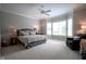 Spacious main bedroom offers plush carpet, ample natural light, and a ceiling fan at 2223 Shaftesbury Rd, Carmel, IN 46032