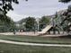 Community playground with swings and a slide at 2223 Shaftesbury Rd, Carmel, IN 46032
