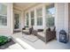 Inviting front porch with seating area, offering a cozy space to relax and enjoy the outdoors at 2223 Shaftesbury Rd, Carmel, IN 46032