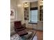 Sitting room with a cozy chair, ottoman, bookshelves and a window bench at 2223 Shaftesbury Rd, Carmel, IN 46032