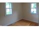 Bright bedroom with hardwood floors and natural light from two windows at 229 Arnold St, Morgantown, IN 46160