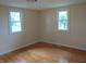 Comfortable bedroom with hardwood floors and two windows at 229 Arnold St, Morgantown, IN 46160