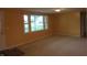 Bright living room with neutral carpet and a large window offering plenty of natural light at 229 Arnold St, Morgantown, IN 46160