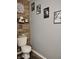 Half bathroom featuring unique wall art and a decorative wood accent wall at 2432 Bridlewood Dr, Franklin, IN 46131