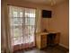 Bedroom with a wood desk, chair, mounted TV, and window with pink star-patterned curtains at 2432 Bridlewood Dr, Franklin, IN 46131