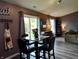 Dining area with seating for four and sliding glass door to the backyard at 2432 Bridlewood Dr, Franklin, IN 46131