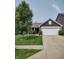 Inviting single-story home with manicured lawn, flowering bushes, and a two-car garage at 2432 Bridlewood Dr, Franklin, IN 46131