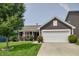 Charming home featuring a manicured lawn and a two-car garage, complemented by rose bushes at 2432 Bridlewood Dr, Franklin, IN 46131