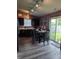 Cozy kitchen features gray cabinets, a table with four chairs, and sliding glass doors to the backyard at 2432 Bridlewood Dr, Franklin, IN 46131