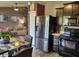 Open kitchen with stainless steel appliances and an adjacent living area at 2432 Bridlewood Dr, Franklin, IN 46131