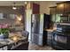 The kitchen has stainless steel appliances, a ceiling fan, and flows seamlessly into the living room at 2432 Bridlewood Dr, Franklin, IN 46131