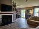 Stylish living room features a fireplace, dining area, sliding glass doors, and hardwood floors at 2432 Bridlewood Dr, Franklin, IN 46131