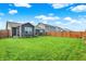 Spacious backyard with lush lawn, a wooden fence, and gray siding at 2538 Bridlewood Dr, Franklin, IN 46131