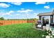 Expansive backyard with lush lawn, wooden fence, patio, grill, and outdoor seating area at 2538 Bridlewood Dr, Franklin, IN 46131