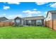 Backyard with lush lawn, grill, patio set, and wooden fence, perfect for outdoor enjoyment at 2538 Bridlewood Dr, Franklin, IN 46131