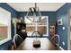 Dining room with blue walls, wooden table and chairs, and a rustic cabinet at 2538 Bridlewood Dr, Franklin, IN 46131