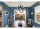 Dining room with blue walls, wooden table and chairs, and sliding glass doors to the backyard at 2538 Bridlewood Dr, Franklin, IN 46131