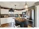 Bright kitchen with white cabinets, a center island, stainless steel appliances, and decorative accents at 2538 Bridlewood Dr, Franklin, IN 46131