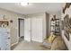 Living room with neutral decor and shelving unit alongside a comfortable sofa and closet space at 2538 Bridlewood Dr, Franklin, IN 46131