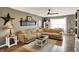 Inviting living room featuring a sectional couch, decorative shelving, and a ceiling fan at 2538 Bridlewood Dr, Franklin, IN 46131