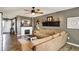 Cozy living room with a fireplace, ceiling fan, and comfortable sectional couch at 2538 Bridlewood Dr, Franklin, IN 46131