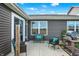 View of the cozy outdoor patio with seating, a grill, and gray siding at 2538 Bridlewood Dr, Franklin, IN 46131