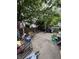 Fenced backyard with patio area, a variety of outdoor furniture, and overgrown grass, plus a fair amount of junk at 2627 Lincoln St, Anderson, IN 46016