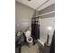 Bathroom features a toilet, shower/tub combination with shower curtain and some patching on the walls at 2627 Lincoln St, Anderson, IN 46016