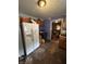 View of a kitchen featuring an older refrigerator and wood cabinets, and connected living space at 2627 Lincoln St, Anderson, IN 46016