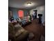View of a living room with blue walls, hardwood floors, two couches, and a coffee table with clutter at 2627 Lincoln St, Anderson, IN 46016