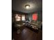 View of a living room with blue walls, hardwood floors, two couches, and a coffee table with clutter at 2627 Lincoln St, Anderson, IN 46016