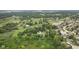 Aerial view showing house surrounded by a pond, neighborhood, green spaces and trees at 2871 Mullinix Rd, Greenwood, IN 46143