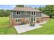 Back view featuring a concrete patio with outdoor seating and lush green backyard at 2871 Mullinix Rd, Greenwood, IN 46143