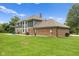 Lush backyard featuring a patio area, mature trees, and the rear facade of the residence at 2871 Mullinix Rd, Greenwood, IN 46143