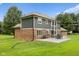 Backyard view showcasing a brick and gray home with a patio, perfect for outdoor entertaining at 2871 Mullinix Rd, Greenwood, IN 46143